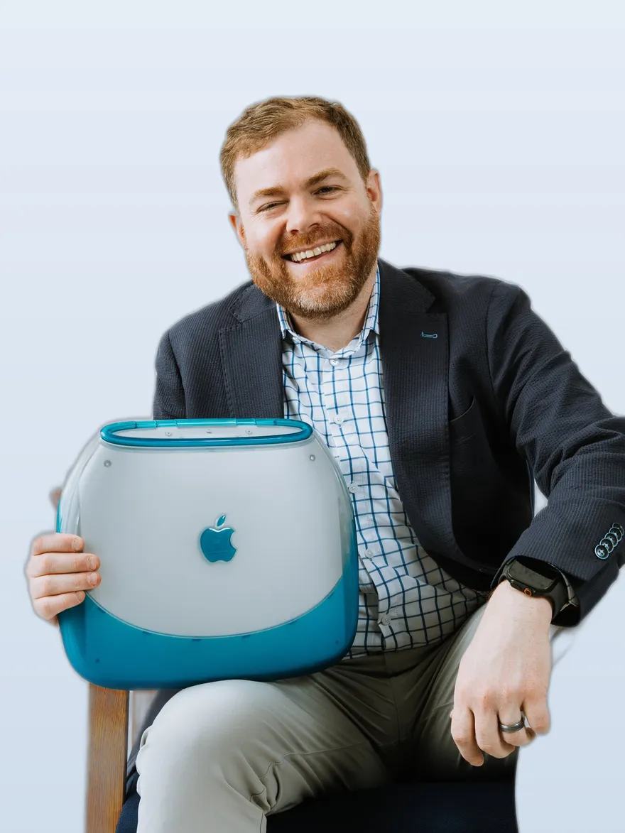 Jon Taylor holding a clamshell iBook
